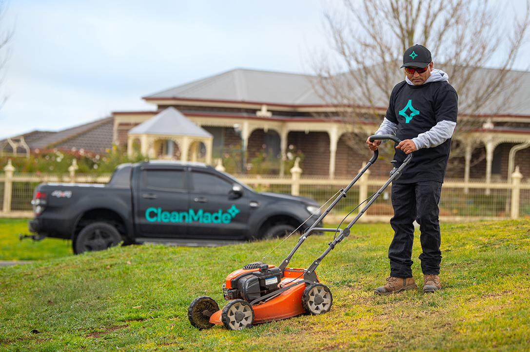 cleanmade technician mowing the lawn