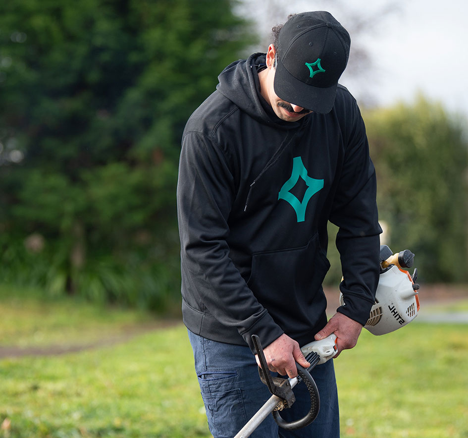 man using grass cutting machine for council government