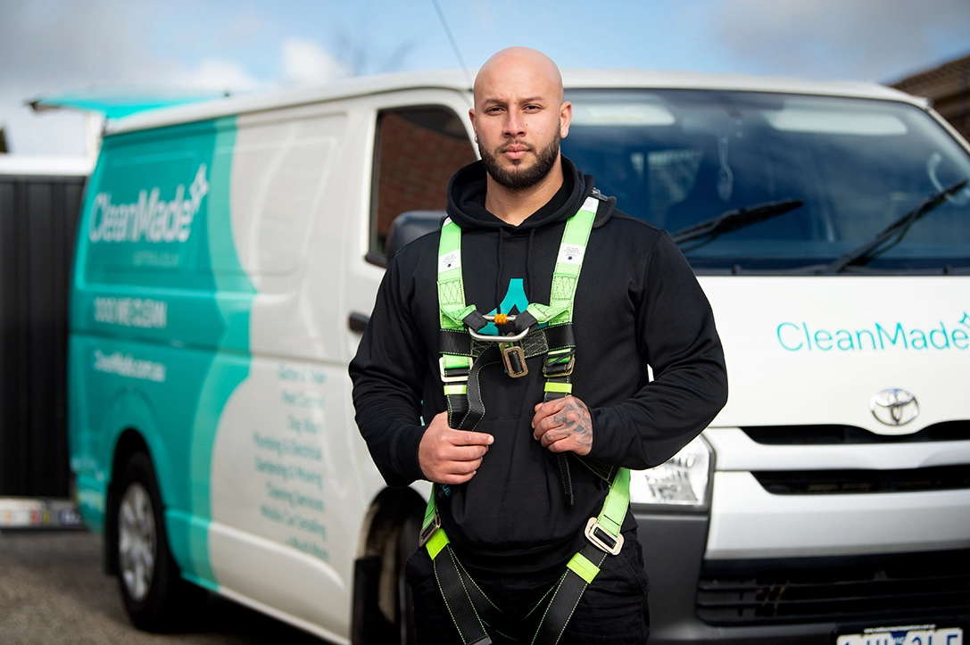 cleanmade technician dressed in harness ready to go clean gutters, roofs, solar panels or install gutter guard, bird-proofing mesh, or bird spikes